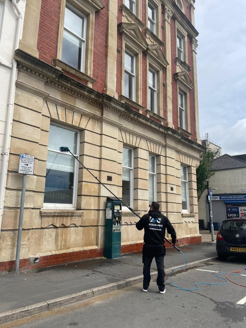 Aqua Pro cleaner using a water-fed pole to clean windows